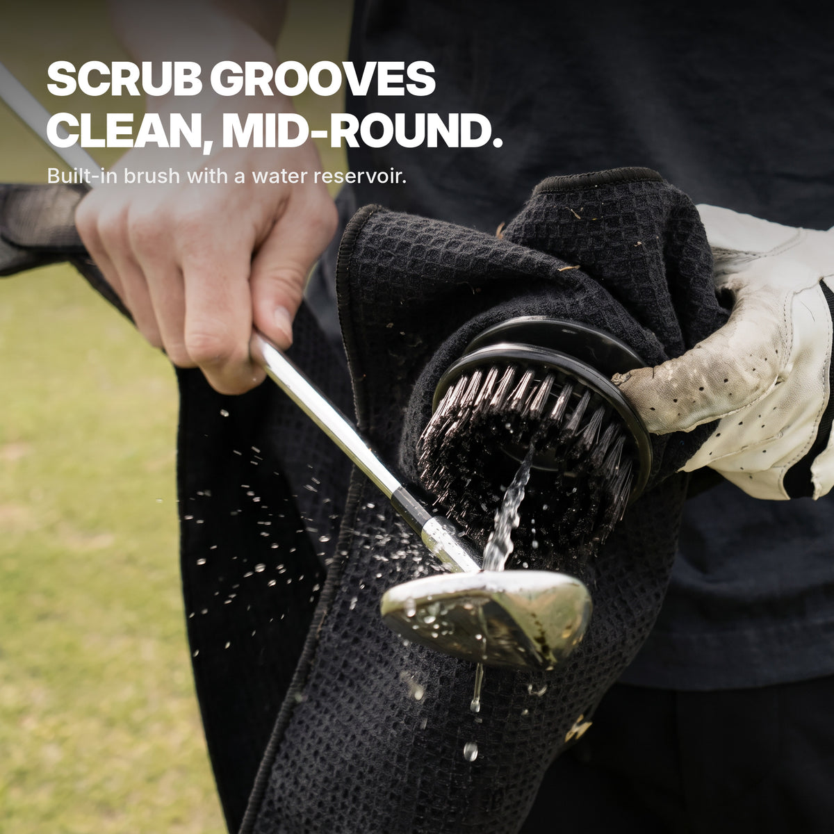 Golfer cleaning club grooves with the Ryft towel's built-in brush and water reservoir