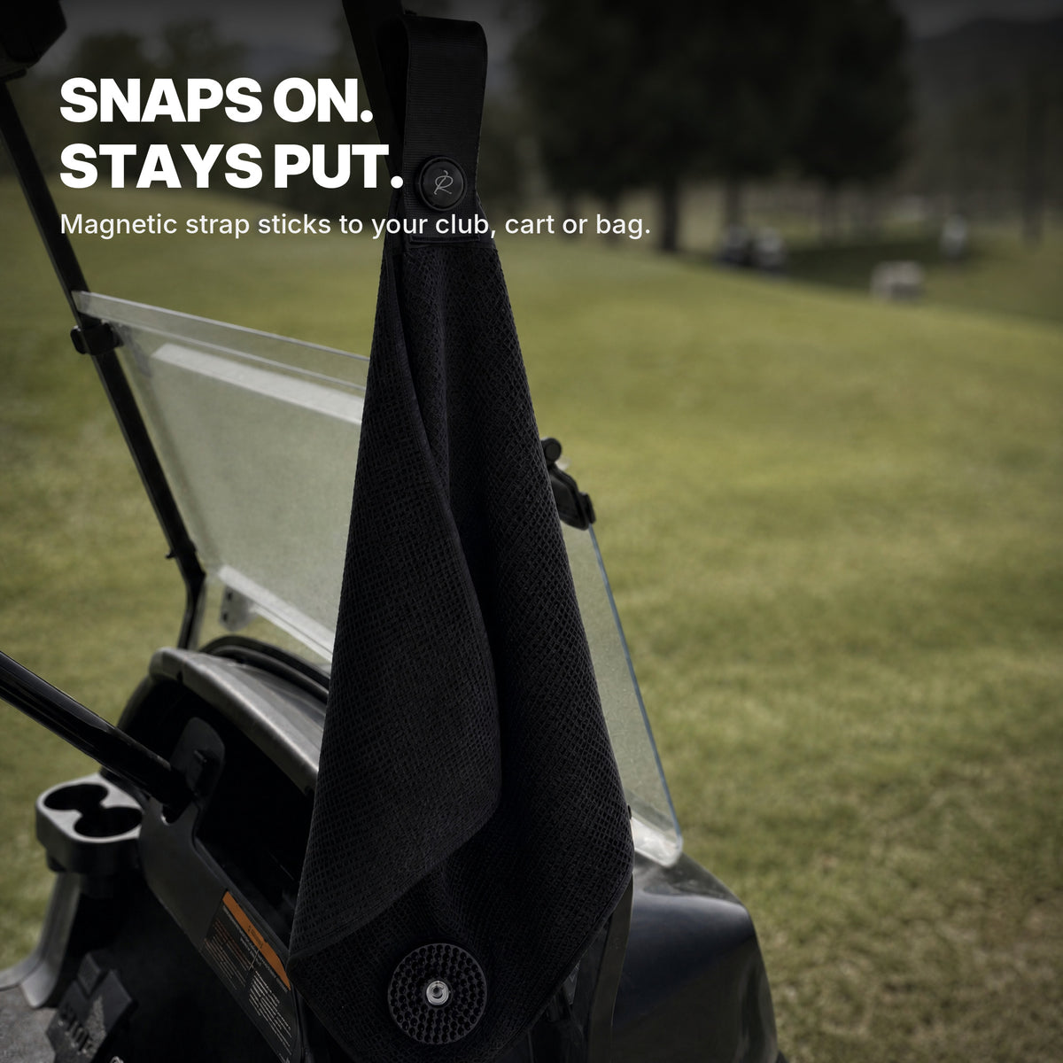 Ryft Golf Towel hanging magnetically from a golf cart on the course